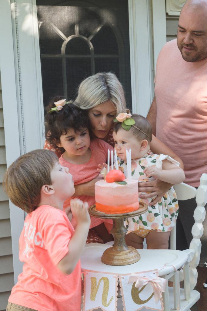 Birthday Girl getting help from her siblings to blow out her candles
